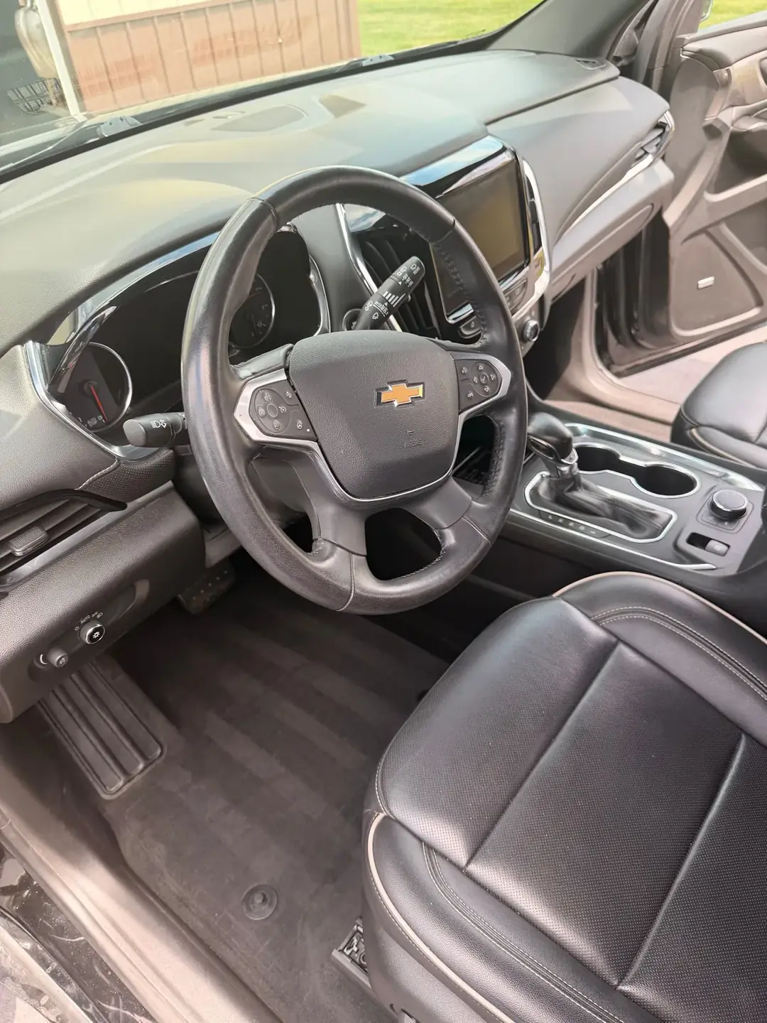 Steering wheel, dash and front seats of a Chevrolet after an interior detail