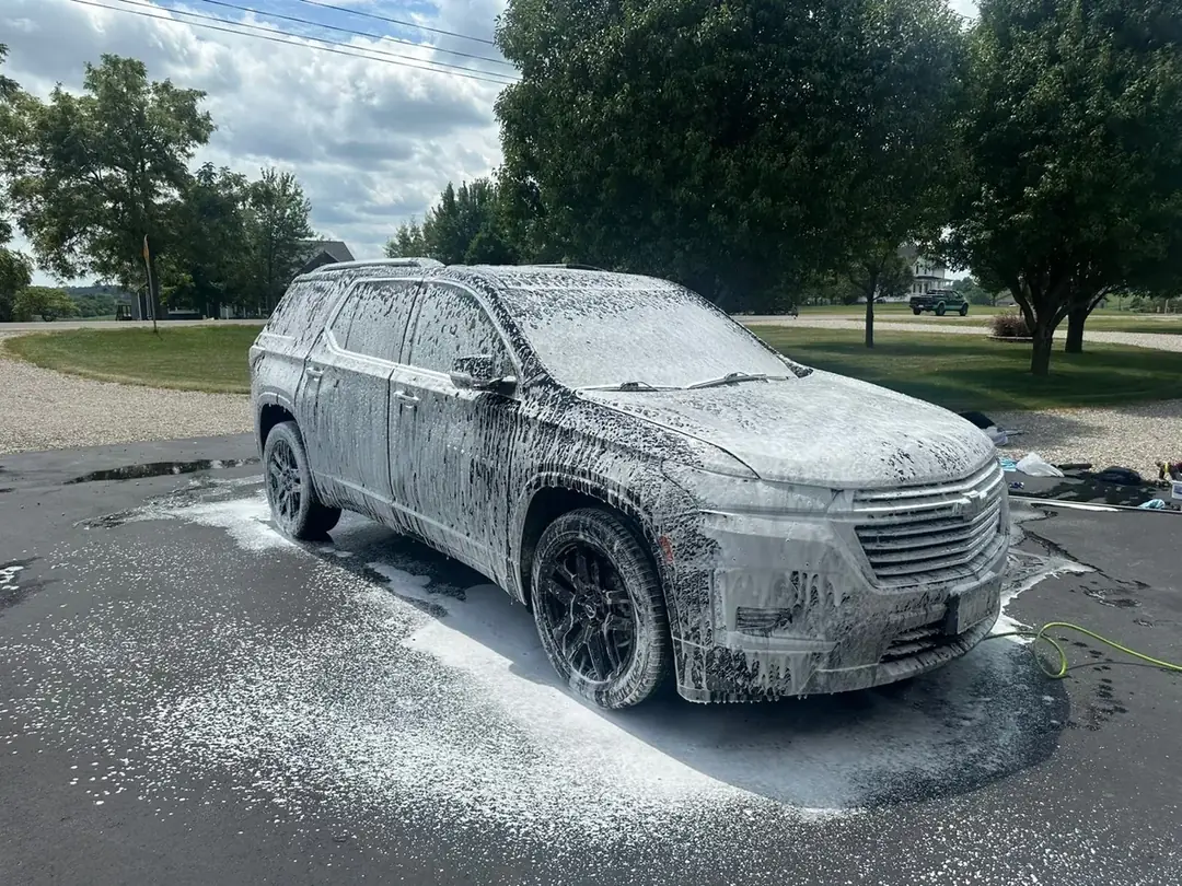 SUV covered in foam during a hand wash